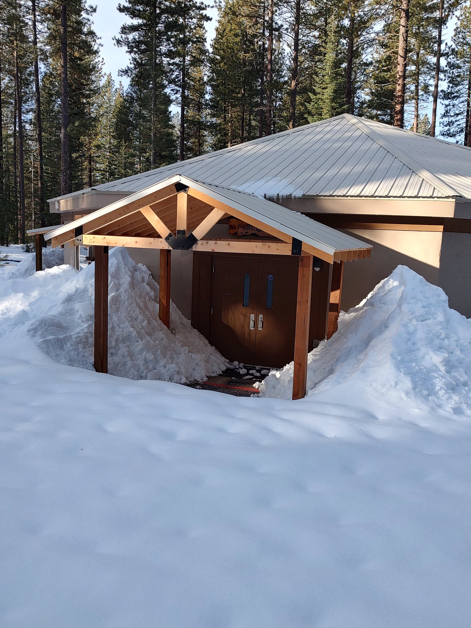 The new porticos installed last year are doing a great job of keeping snow away from the doors…but the surrounding areas are blanketed in several feet of snowpack.