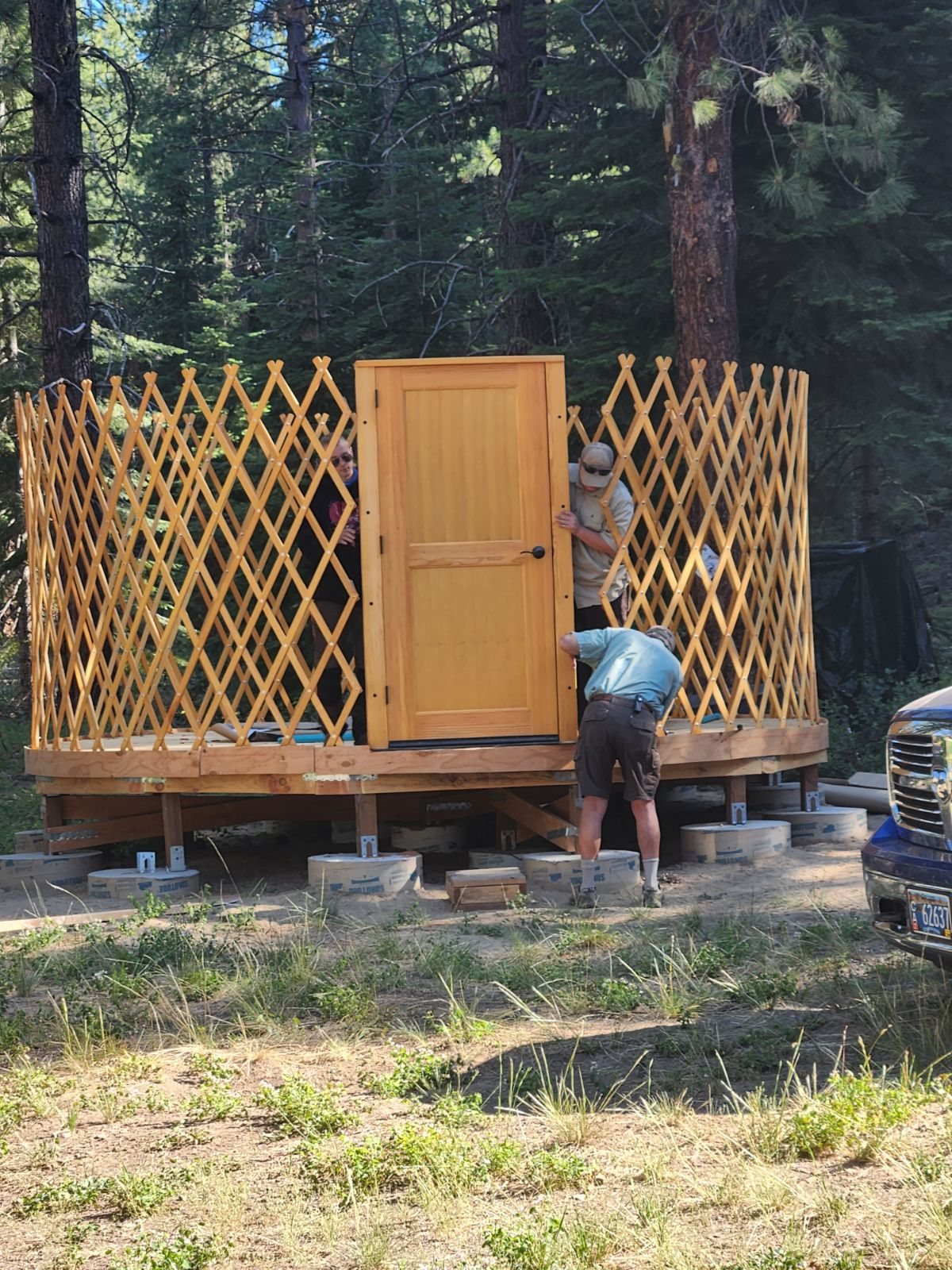 Volunteers working away on one of our staff yurts, building the ‘walls’ and making sure everything fits together
