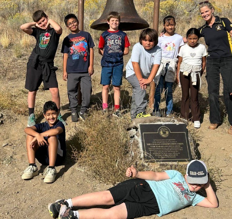 4th graders pose with their teacher after a strenuous hike