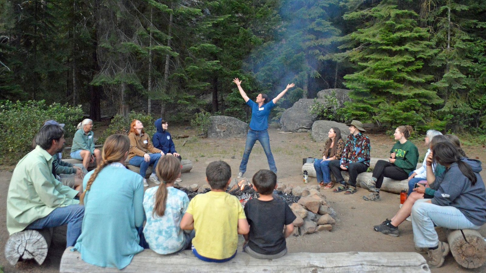 Former instructor turned high school teacher Marlena McPherson shares a new “Scientist!” campfire song with the group. Kevin plans to use it for every residential program.