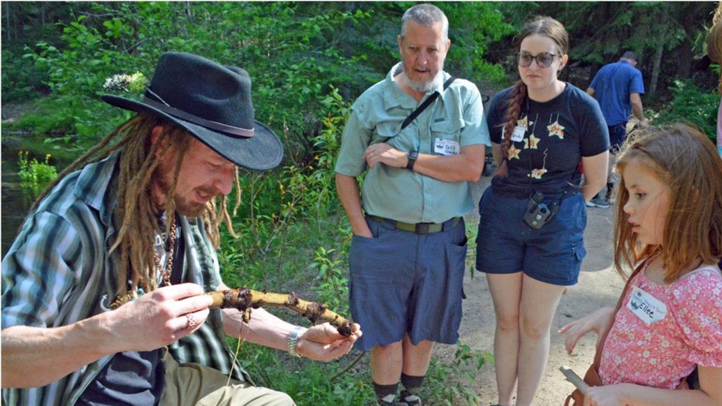 Board Vice President Jeff Sparks (center) watches on as Instructor Sam (left) discusses some of the aquatic life down at the headwaters of the Wood River.