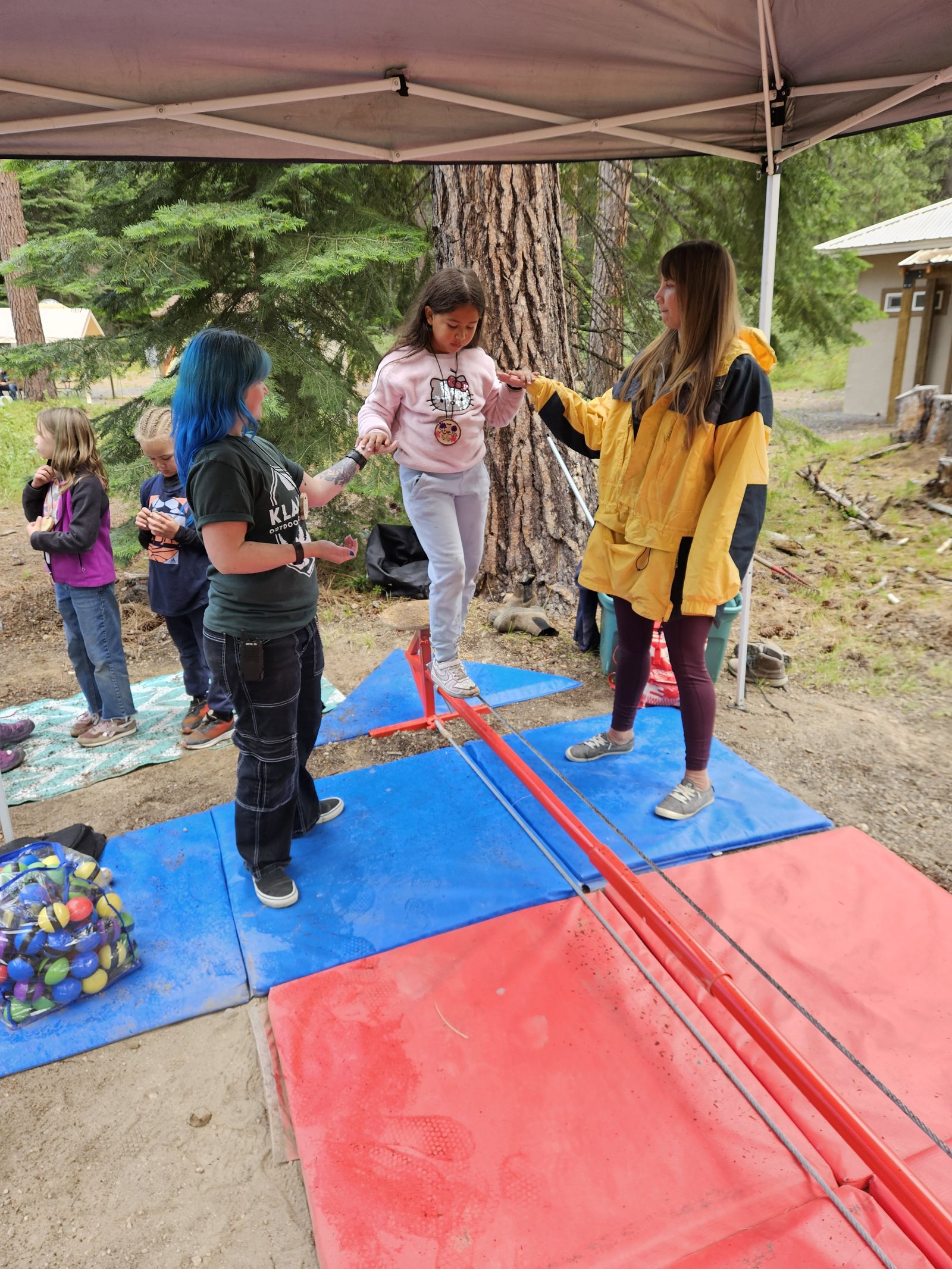 Volunteer April teaches tightrope with KOSS instructor, Meagan