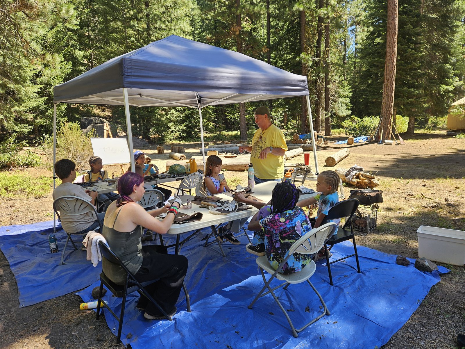 Elder of the Klamath Tribes, Perry Chocktoot, teaches hands-on arrowhead flintknapping. Campers were able to take home their obsidian creations