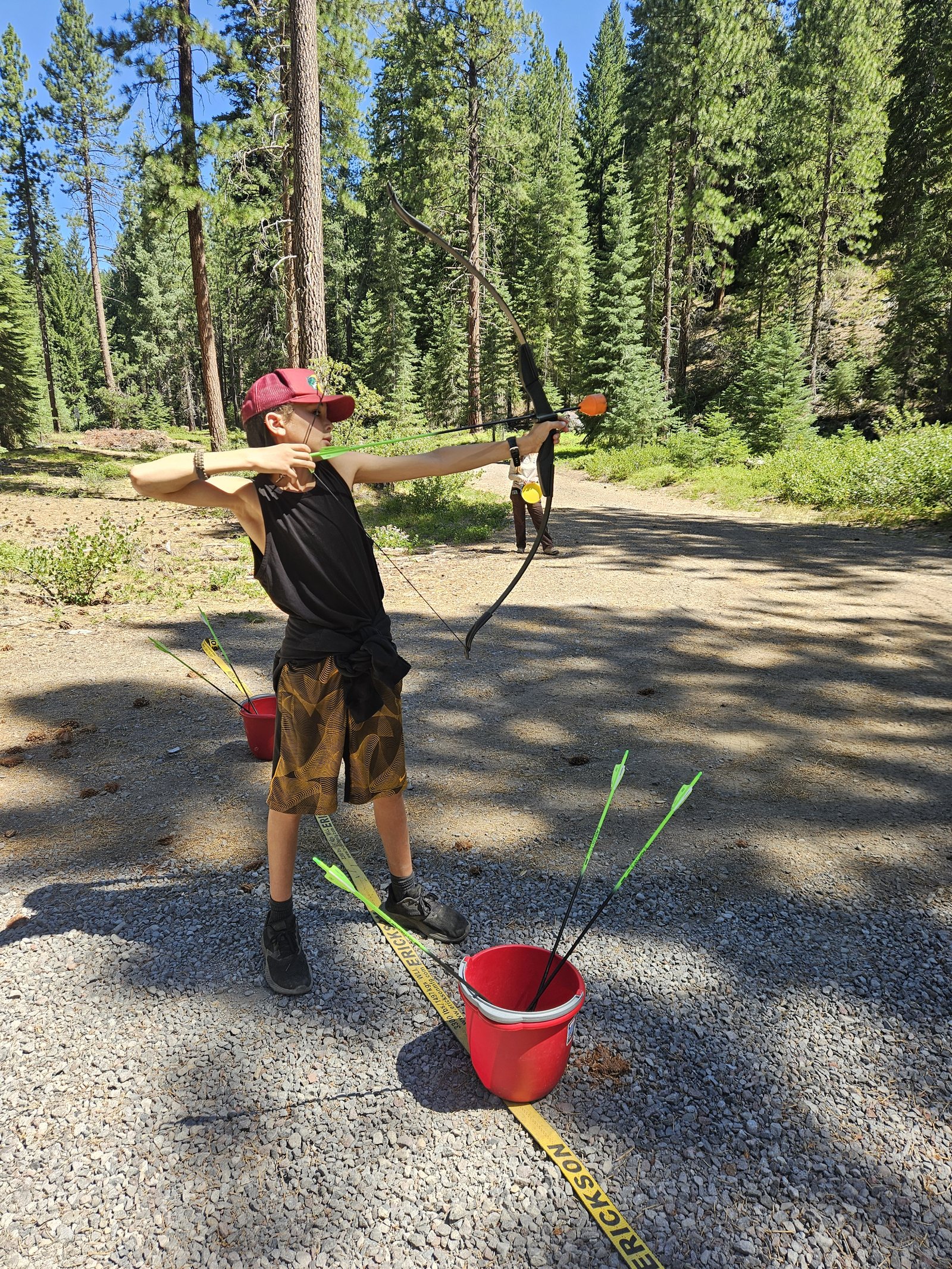 A camper takes aim at a moving target (that he hit)! Thanks to the Fish and Wildlife Service for bringing up their equipment and teaching archery