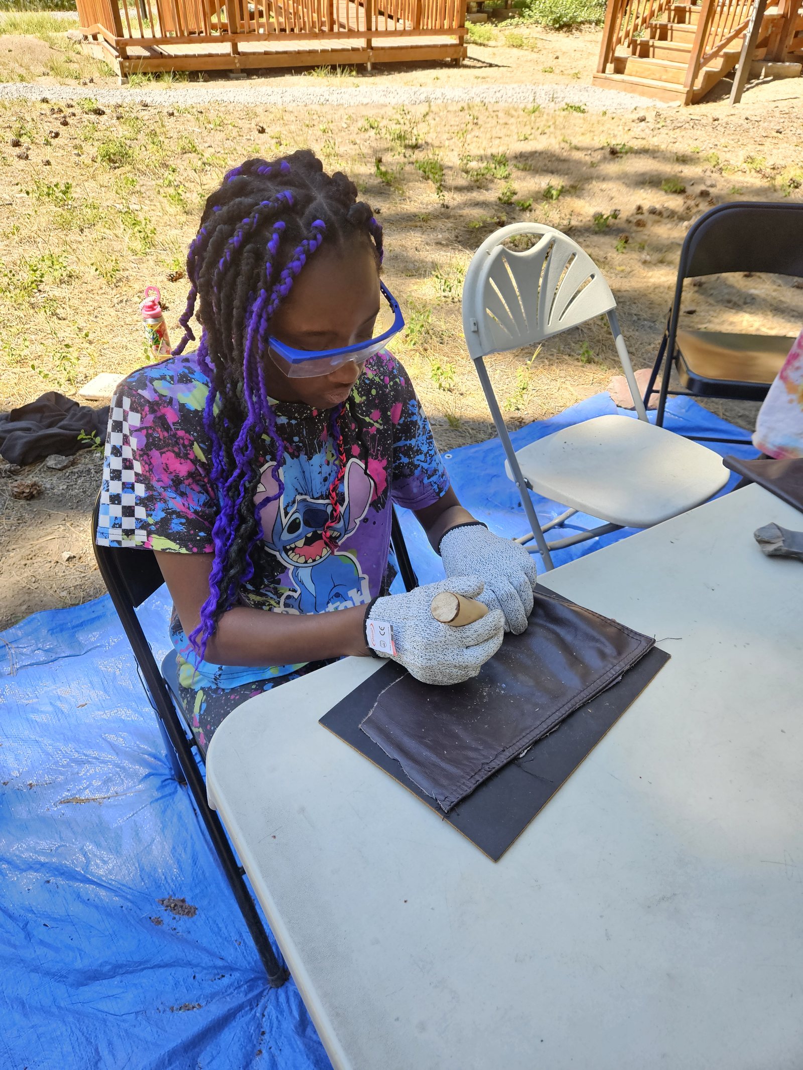 Diligently working on an arrowhead, this camper chipped away at obsidian with a copper rod until she created a sharp point