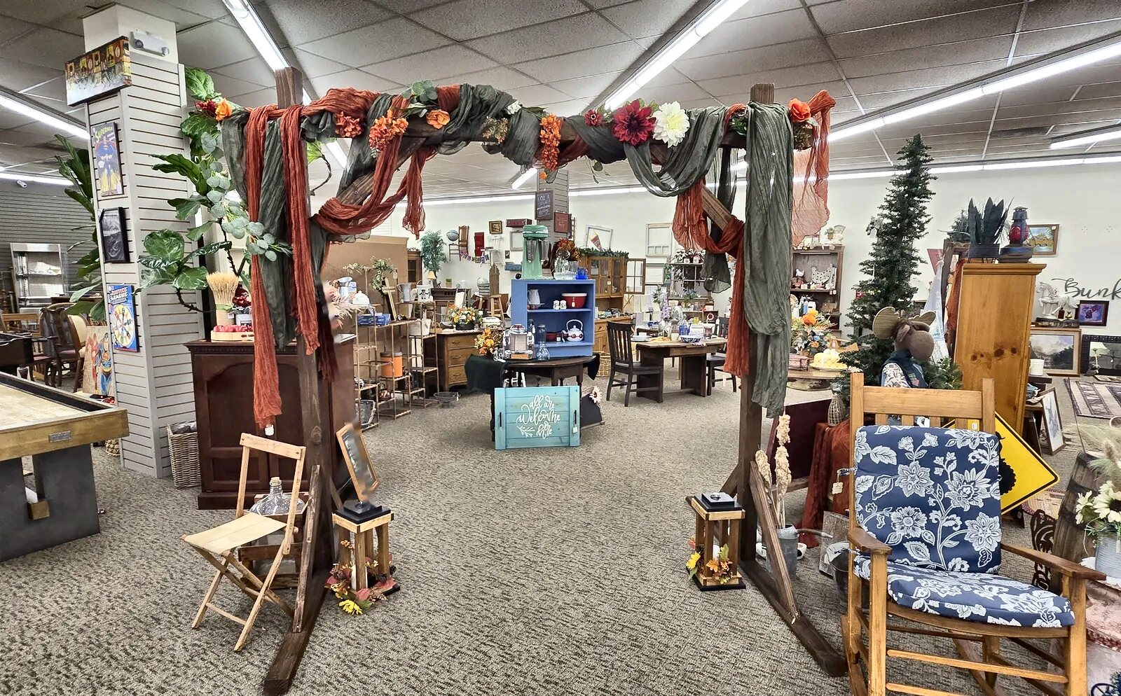 A fall-decorated garden arch welcomes shoppers inside Honey & Ivy Collective in Klamath Falls
