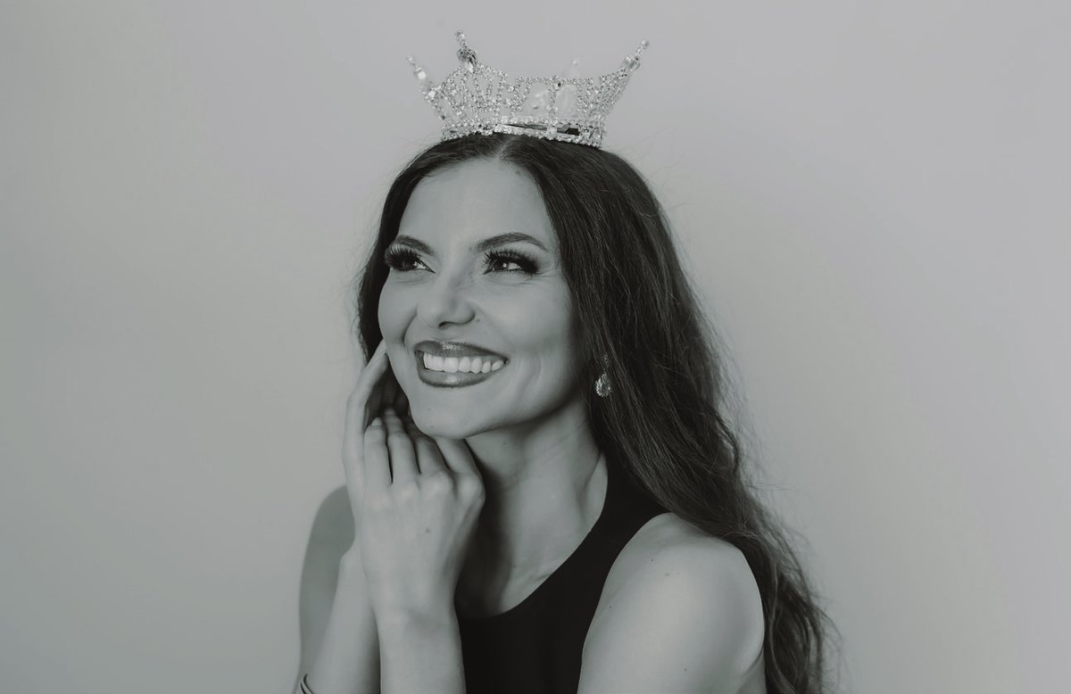 Black-and-white portrait of Allyssa Defillipo smiling, wearing the Miss Oregon crown