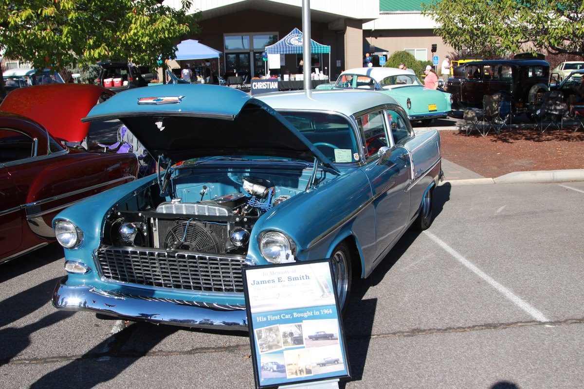 A classic Chevrolet with its hood raised at a Crosspoint Christian School car show
