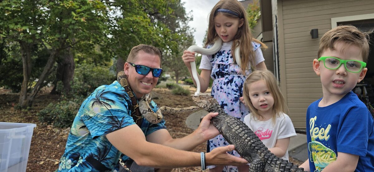 James and the kids meet El Chompo the dwarf caiman — with a boa and a white snake along for the ride