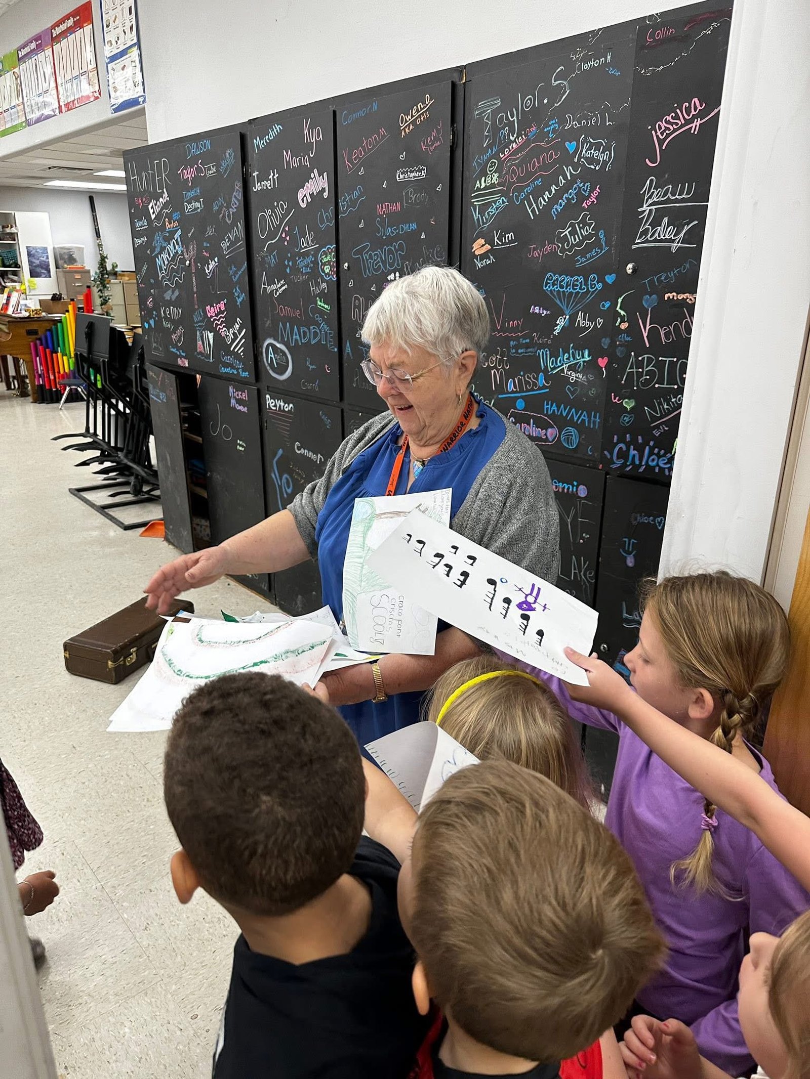 A Crosspoint Christian School teacher working a counting board with a circle of young students