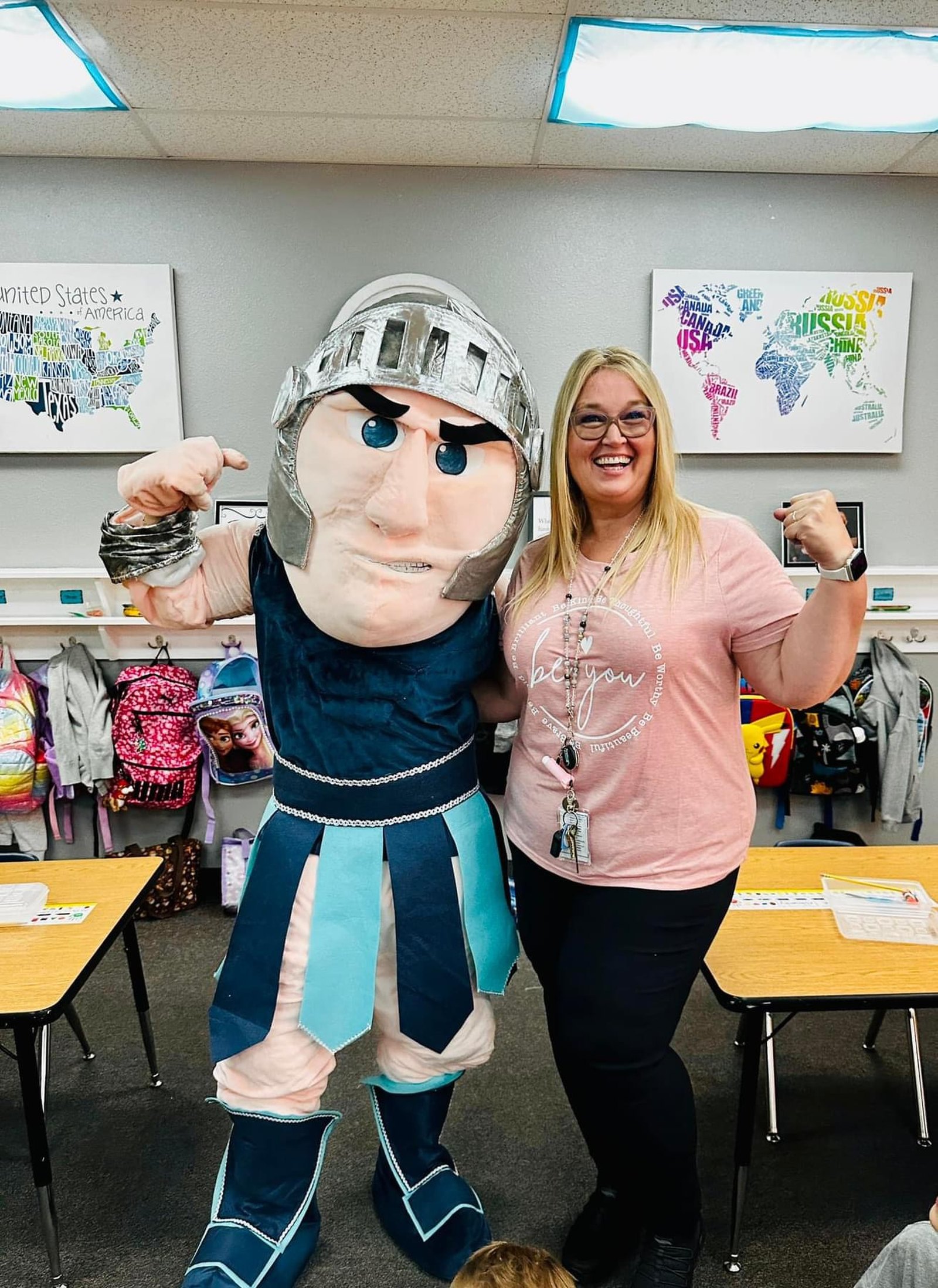 The Crosspoint Warrior mascot beside a teacher in a Crosspoint Christian School classroom