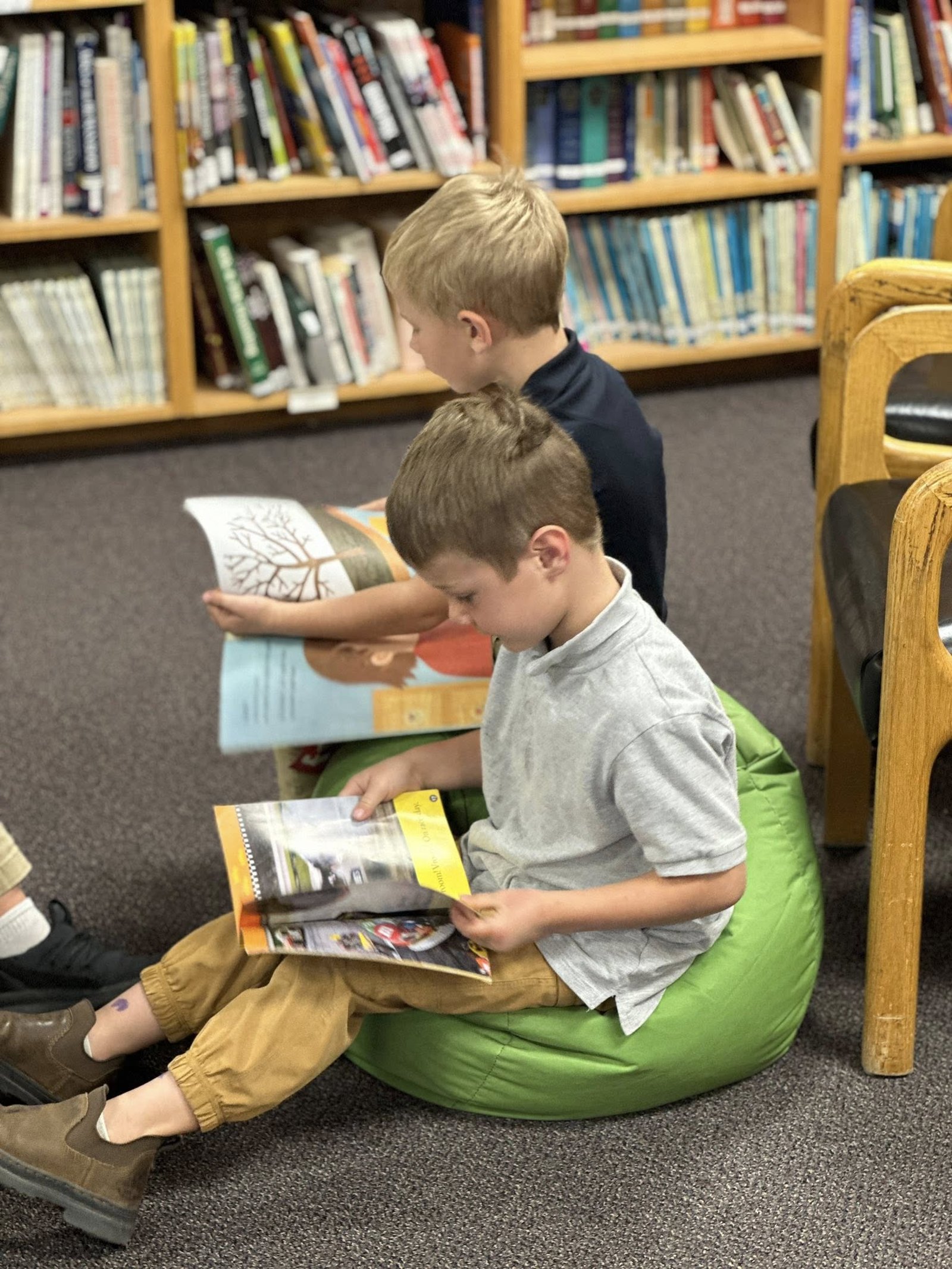A Crosspoint Christian School student reading on a beanbag in the school library